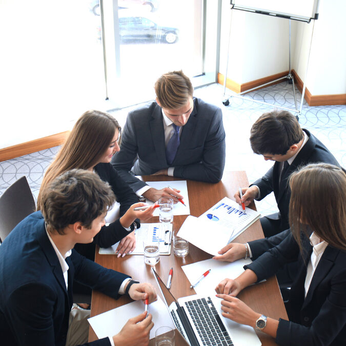 business meeting in an office, the businesspeople are discussing a document.